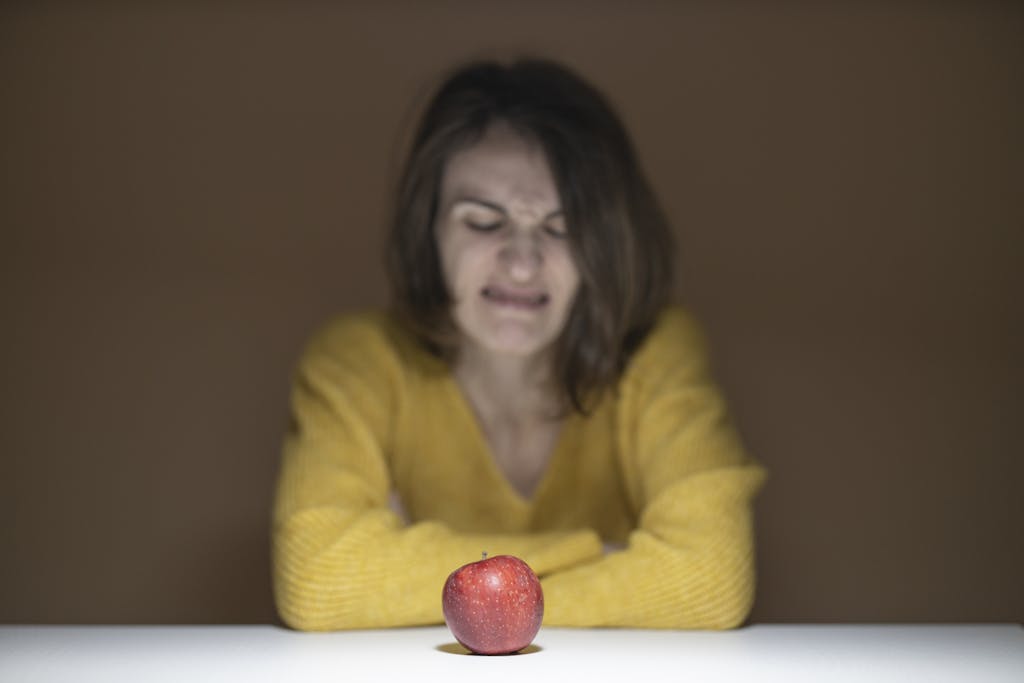 Woman Disgusted Looking at the Apple